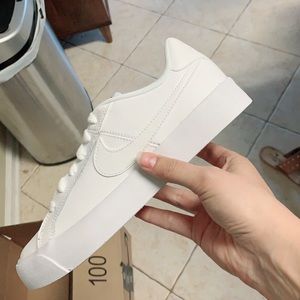 Lightly worn, white Nike sneakers